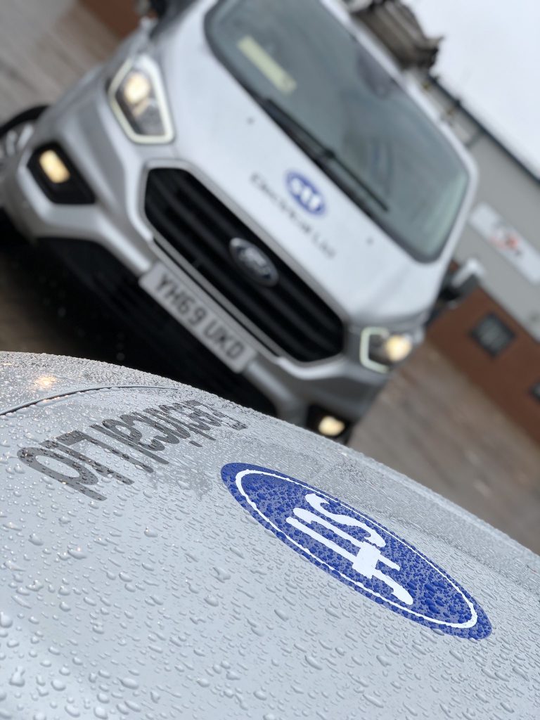 Two STF Electrical Ltd vans parked outside a commercial property in Liverpool, showcasing our commitment to efficient service delivery.