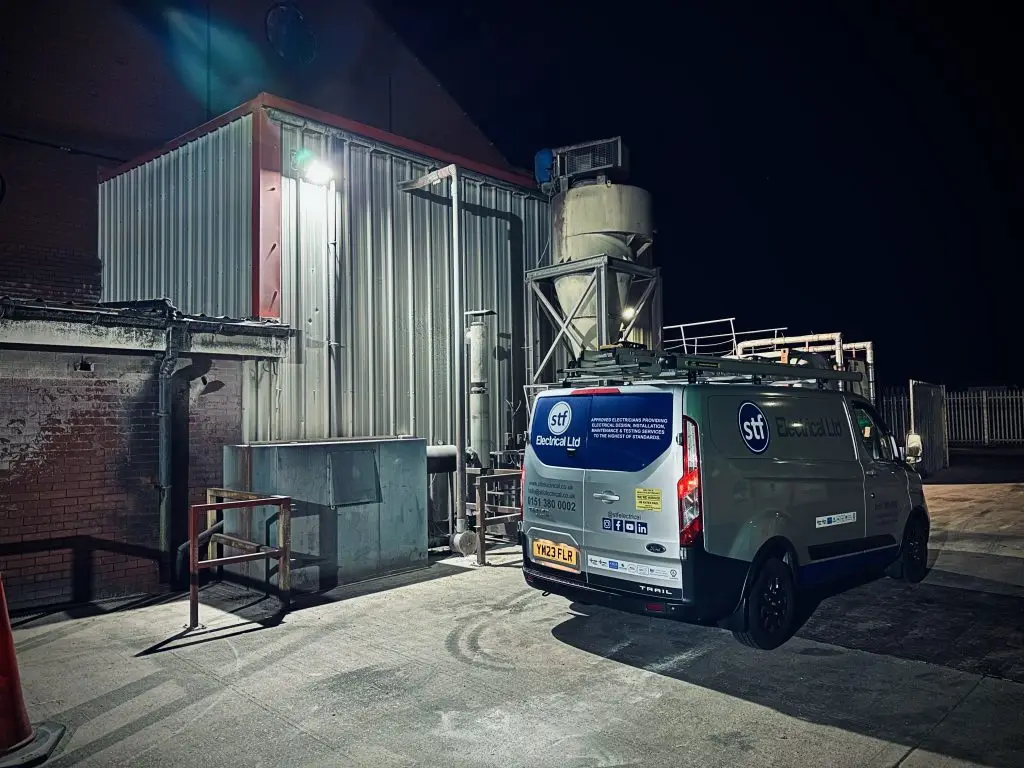 STF Electrical Ltd van parked outside an industrial warehouse, ready to deliver expert electrical services.